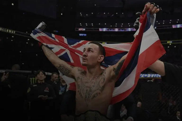 Conor McGregor flexing muscles during UFC 329 weigh-in event.