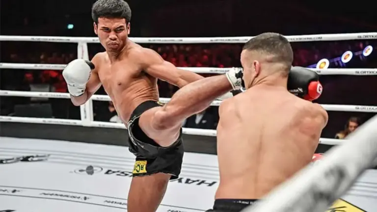 GLORY kickboxing ring with fighters preparing for a match in a packed arena.
